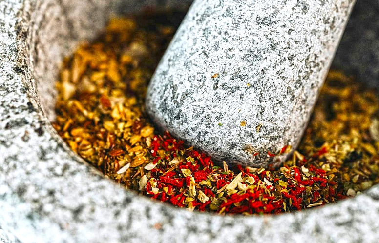 crushing spices with a pestle and mortar